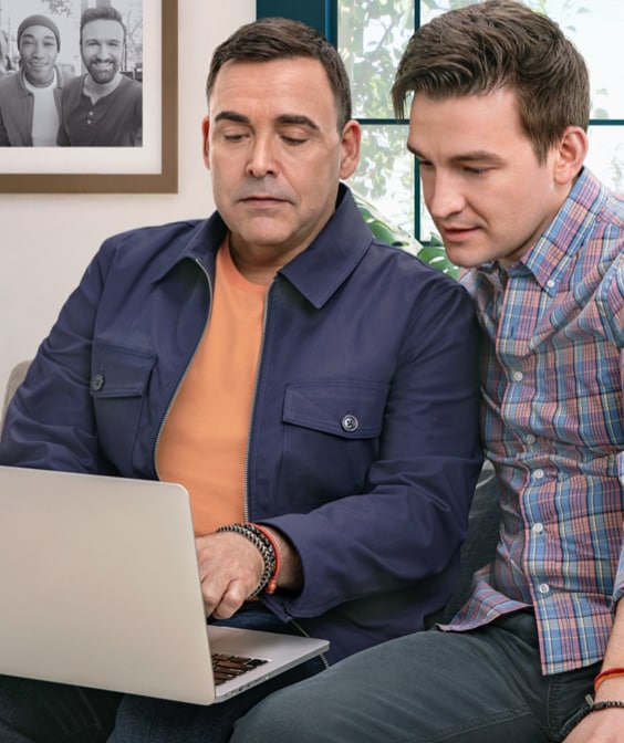 Male partners reviewing resources on laptop, not actual Serostim® patients