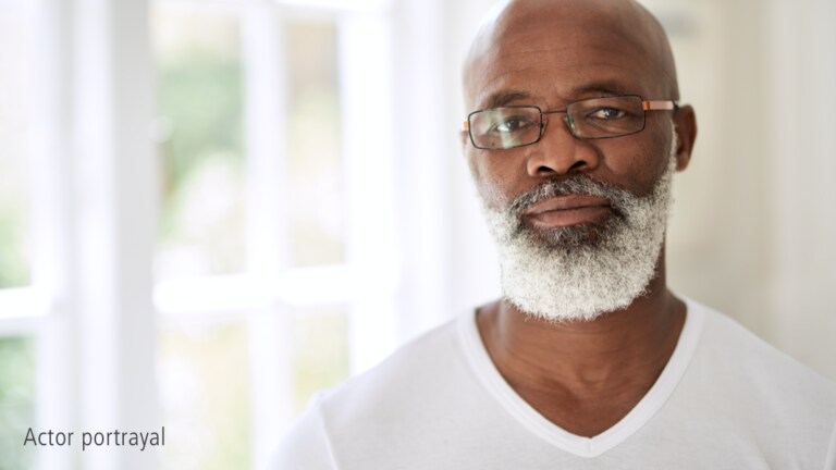 Older bald black male with white beard representing hypothetical Serostim® patient, Marcus, actor portrayal