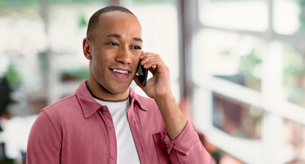 Mixed ethnicity male talking on smartphone, not actual Serostim® patient