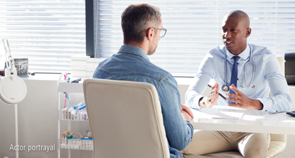 Young black male portraying doctor and older white male discussing, not actual Serostim® patients