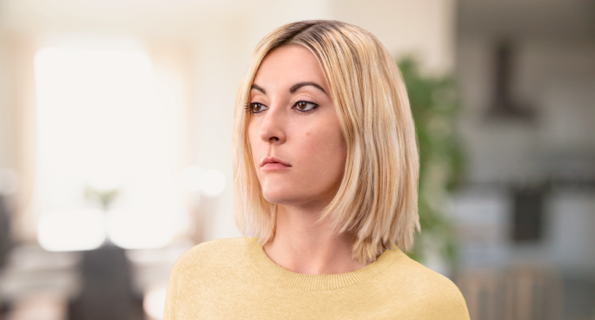 White female in a yellow sweater, not actual Serostim® patient