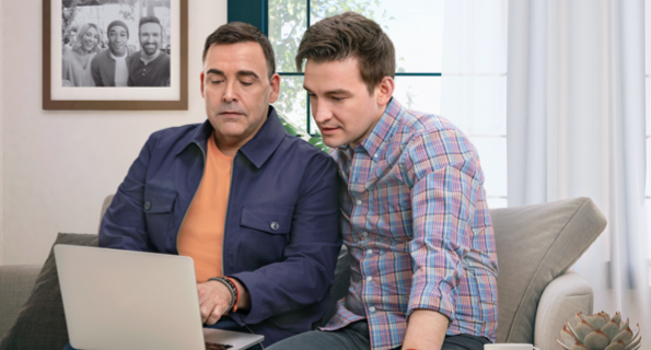 Male partners reviewing resources on laptop, not actual Serostim® patients