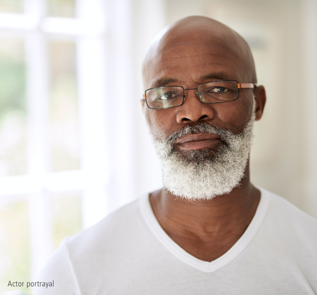 Older bald black male with white beard representing hypothetical Serostim® patient, Marcus, actor portrayal
