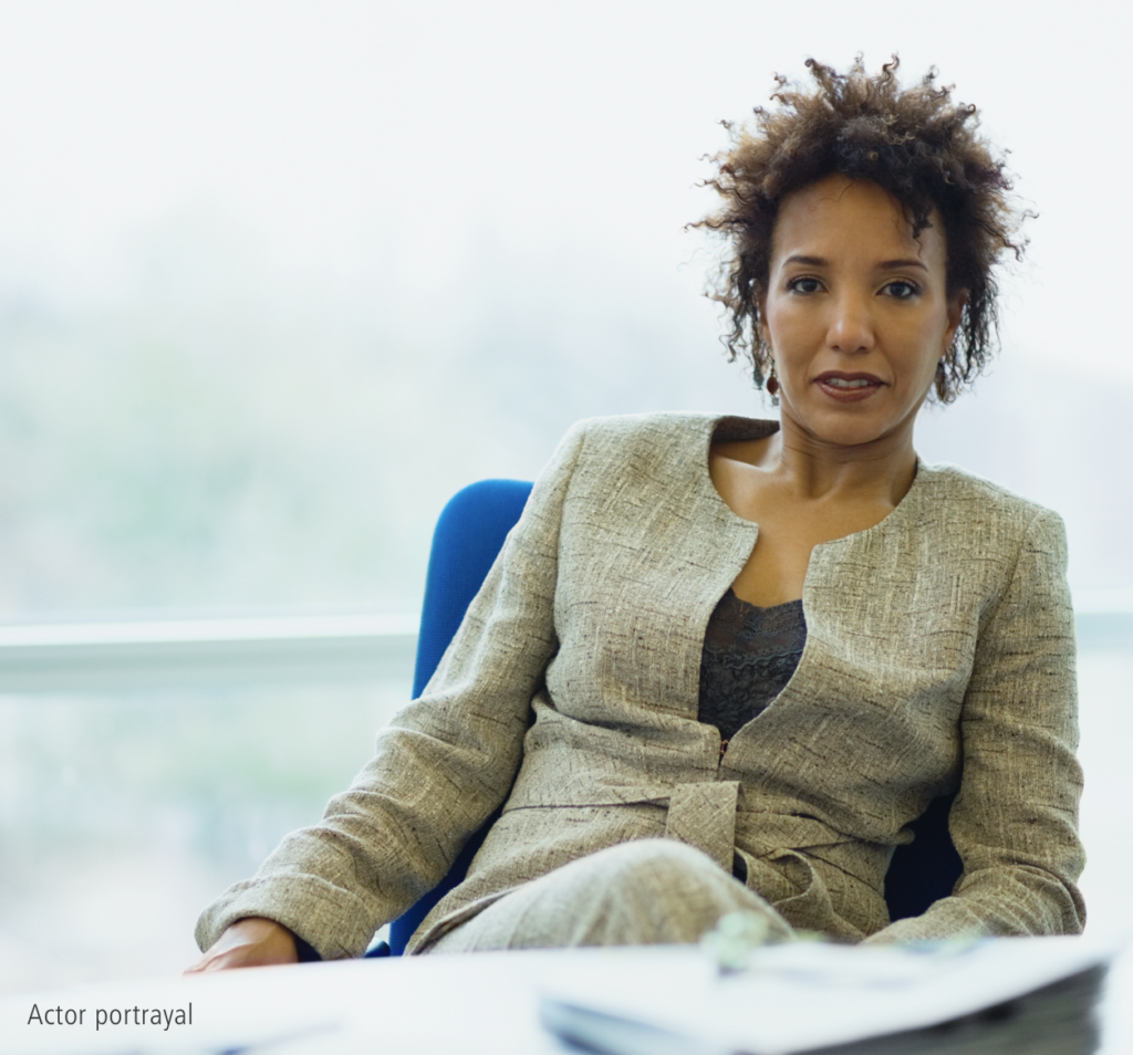 Black female in beige suit representing hypothetical Serostim® patient, Natalie, actor portrayal